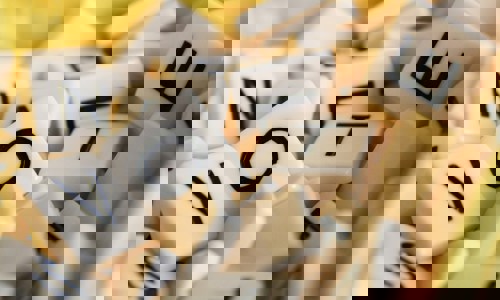 A pile of Scrabble tiles spelling out the word VOTE